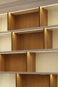 Bibliothèque blanc et bois lumineux dans un appartement parisien rénové par Interface Design